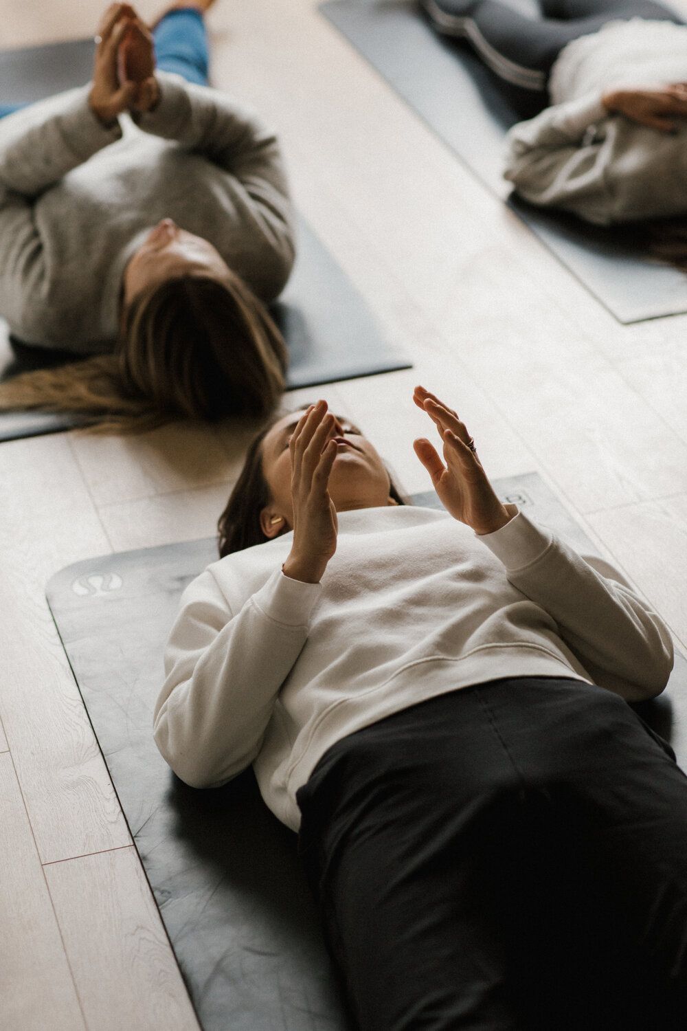 A facilitator demonstrating a slow balance pattern to a seated group